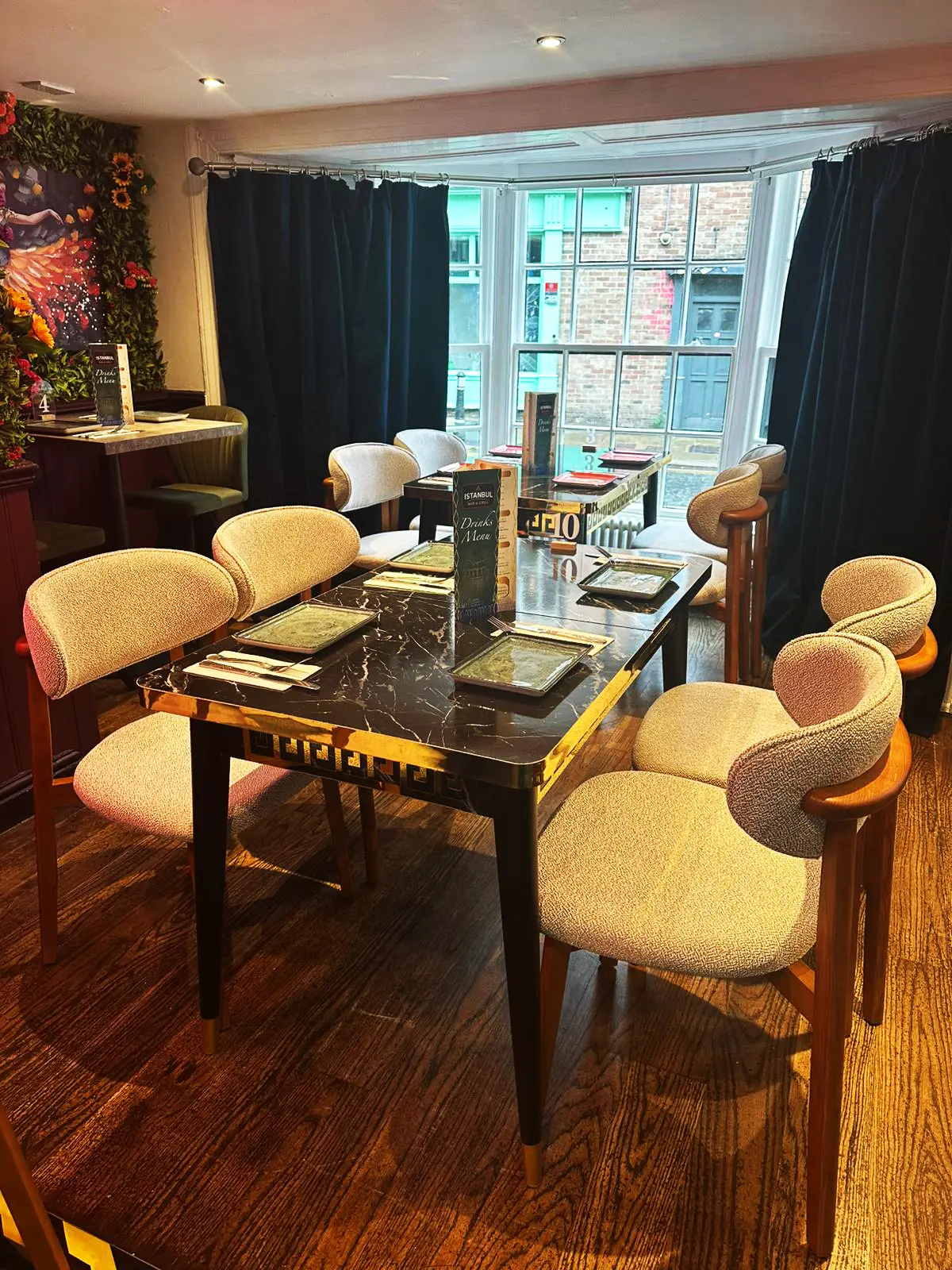 Soft dining chairs around a dark marble table